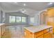 Living room with large windows overlooking the landscaped backyard and fireplace at 2383 Rainswept Ave, Henderson, NV 89052