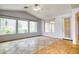 Spacious living area with large windows, tile flooring, ceiling fan, and access to the backyard at 2383 Rainswept Ave, Henderson, NV 89052