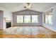 Bright living room boasts vaulted ceilings, fireplace, and multiple windows offering ample natural light at 2383 Rainswept Ave, Henderson, NV 89052