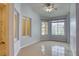 Bright living room boasting tile flooring, large windows and ceiling fan lighting at 2383 Rainswept Ave, Henderson, NV 89052