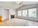Comfortable living space with a fireplace, tile floors, and large windows providing lots of sunlight at 2383 Rainswept Ave, Henderson, NV 89052