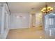 Open concept living room featuring tile flooring, neutral walls and chandelier lighting at 2383 Rainswept Ave, Henderson, NV 89052