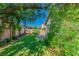 Picturesque backyard with a well-manicured lawn, mature tree providing shade, and patio offering a private retreat at 2409 Cockatiel Dr, North Las Vegas, NV 89084