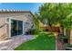 Beautiful backyard with lush greenery, a paver patio, artificial turf and a built-in BBQ, perfect for entertaining at 2409 Cockatiel Dr, North Las Vegas, NV 89084
