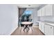 A dining area with a table near a sliding glass door provides backyard access and natural light at 2409 Cockatiel Dr, North Las Vegas, NV 89084