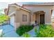 Charming home featuring a well-maintained front yard and inviting covered entryway, perfect for welcoming guests and relaxing at 2409 Cockatiel Dr, North Las Vegas, NV 89084