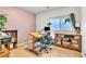 Functional home office with desk, shelving, and natural light at 2409 Cockatiel Dr, North Las Vegas, NV 89084