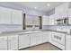 Updated kitchen features white cabinets, stainless steel appliances, and ample counter space for cooking and entertaining at 2409 Cockatiel Dr, North Las Vegas, NV 89084