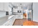 Bright kitchen with white cabinets, stainless steel appliances, and an adjacent dining area at 2409 Cockatiel Dr, North Las Vegas, NV 89084