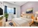 Bedroom features a king bed, contemporary decor, and ample natural light for a serene and inviting retreat at 2409 Cockatiel Dr, North Las Vegas, NV 89084