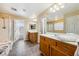 Bright bathroom featuring dual vanities, tile flooring, and a shower over a soaking tub at 248 Hyssop Ct, Henderson, NV 89015