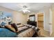 Comfortable bedroom with a ceiling fan, natural light from the window, and an ensuite closet at 248 Hyssop Ct, Henderson, NV 89015