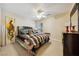 Well-lit bedroom featuring a plush bed, modern dresser, and neutral walls with carpeted flooring at 248 Hyssop Ct, Henderson, NV 89015