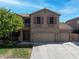 Charming two-story home with a three-car garage, well-manicured lawn, and mature tree at 248 Hyssop Ct, Henderson, NV 89015