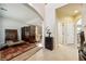 Foyer leading to a living area, featuring tile flooring, artistic decor, and multiple entryways at 248 Hyssop Ct, Henderson, NV 89015