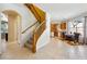 Open foyer featuring a staircase, dining area, and kitchen with tile flooring at 248 Hyssop Ct, Henderson, NV 89015