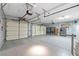 Large three-car garage featuring storage shelves, a refrigerator, and plenty of space at 248 Hyssop Ct, Henderson, NV 89015