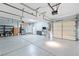 Spacious three-car garage featuring shelving, refrigerator, and ample room for storage at 248 Hyssop Ct, Henderson, NV 89015