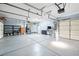 Clean three-car garage with shelving, refrigerator, and plenty of open space for parking at 248 Hyssop Ct, Henderson, NV 89015