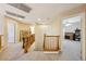 Upstairs hallway featuring wood railing and doorways to bedrooms at 248 Hyssop Ct, Henderson, NV 89015