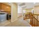 Upstairs hallway featuring carpeted floors, a laundry area, and a wooden banister at 248 Hyssop Ct, Henderson, NV 89015