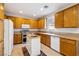 Functional kitchen with wooden cabinets, a center island, and essential appliances at 248 Hyssop Ct, Henderson, NV 89015