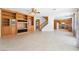 Spacious living room with tile flooring, built-in shelving, and easy access to the kitchen and stairway at 248 Hyssop Ct, Henderson, NV 89015