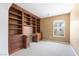 Office area featuring custom wooden built-in shelves and a desk with natural light at 248 Hyssop Ct, Henderson, NV 89015