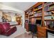 Inviting home office with built-in bookshelves, a comfortable chair, and access to the main bedroom at 248 Hyssop Ct, Henderson, NV 89015