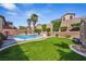 Home's pool is surrounded by a grassy area, block walls, and landscaping at 248 Hyssop Ct, Henderson, NV 89015