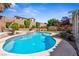 Sparkling blue pool featuring a rock waterfall, desert landscaping, and privacy at 248 Hyssop Ct, Henderson, NV 89015