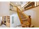 Staircase with carpeted treads and a wooden banister, connecting multiple levels of the home at 248 Hyssop Ct, Henderson, NV 89015