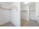 Spacious walk-in closet featuring carpeted floors and wooden rails for ample storage at 248 Hyssop Ct, Henderson, NV 89015