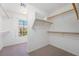 Walk-in closet featuring carpeted floors, wooden rails and shelves for ample storage at 248 Hyssop Ct, Henderson, NV 89015