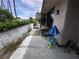 Backyard with gated access, plants, lounge chairs and an umbrella at 2484 Domingo St, Las Vegas, NV 89121