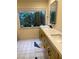 Bathroom featuring a double vanity, modern fixtures, and a large window with view of the outdoors at 2484 Domingo St, Las Vegas, NV 89121