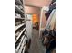 Organized closet space with shelving and clothing racks, connecting to the main bedroom area at 2484 Domingo St, Las Vegas, NV 89121