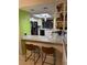 Kitchen featuring granite countertops, white cabinets, and stainless steel appliances with bar stool seating at 2484 Domingo St, Las Vegas, NV 89121