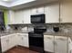 Kitchen featuring white cabinets, granite countertops and stainless steel appliances at 2484 Domingo St, Las Vegas, NV 89121
