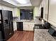 Kitchen featuring granite countertops, white cabinets, and stainless steel appliances at 2484 Domingo St, Las Vegas, NV 89121