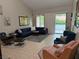 Comfortable living room featuring a sectional sofa, area rug, and natural light from the sliding glass door at 2484 Domingo St, Las Vegas, NV 89121