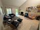 Inviting living room with vaulted ceilings, cozy seating, and sliding door access to the outdoors at 2484 Domingo St, Las Vegas, NV 89121