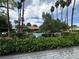 Community pool surrounded by mature palm trees and manicured landscaping, perfect for relaxation at 2484 Domingo St, Las Vegas, NV 89121