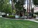 Scenic view of a community pool with mature landscaping and comfortable outdoor seating at 2484 Domingo St, Las Vegas, NV 89121