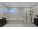 A luxury bathroom with a soaking tub, walk-in shower, and dual vanities at 2518 Veronella St, Henderson, NV 89044