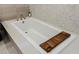 Relaxing bathtub features modern fixtures and a built in wooden caddy at 2518 Veronella St, Henderson, NV 89044