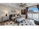 Stylish bedroom featuring a brick accent wall, fan, football decor, and sliding glass doors at 2518 Veronella St, Henderson, NV 89044