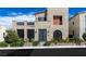 Modern two-story home featuring gray exterior with black slat window coverings and beautiful desert landscaping at 2518 Veronella St, Henderson, NV 89044