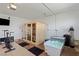 This garage has a sauna, cold tub, exercise equipment, and a wall-mounted television on a speckled epoxy floor at 2518 Veronella St, Henderson, NV 89044