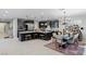 Spacious kitchen with dark cabinets, stainless steel appliances, island, and dining area at 2518 Veronella St, Henderson, NV 89044